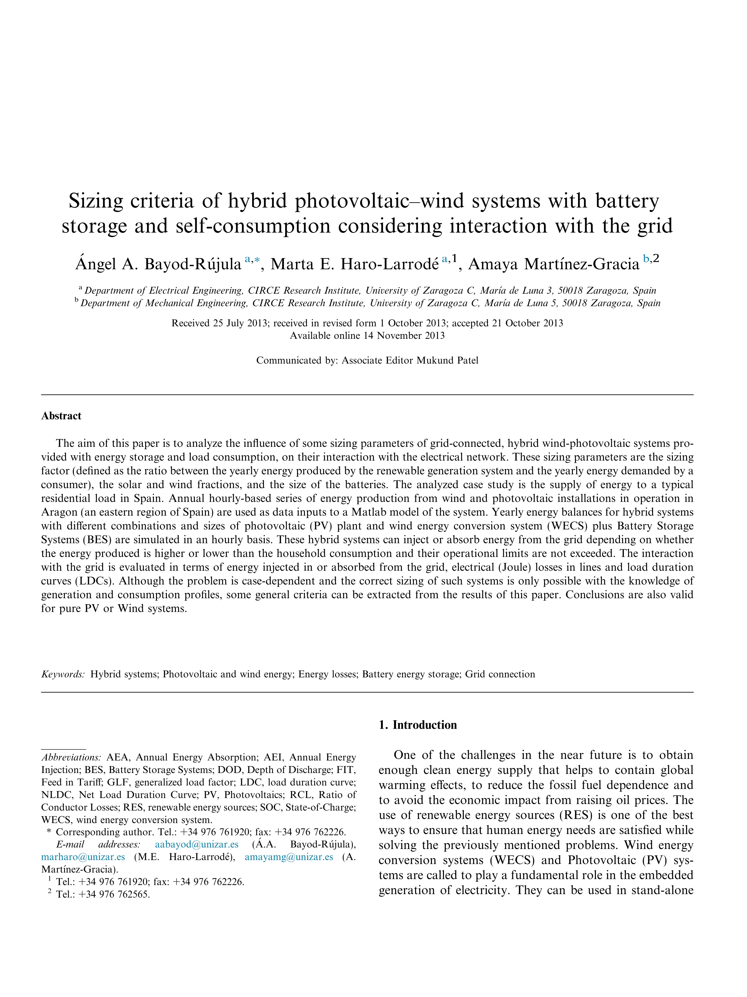 Sizing criteria of hybrid photovoltaic–wind systems with battery storage and self-consumption considering interaction with the grid