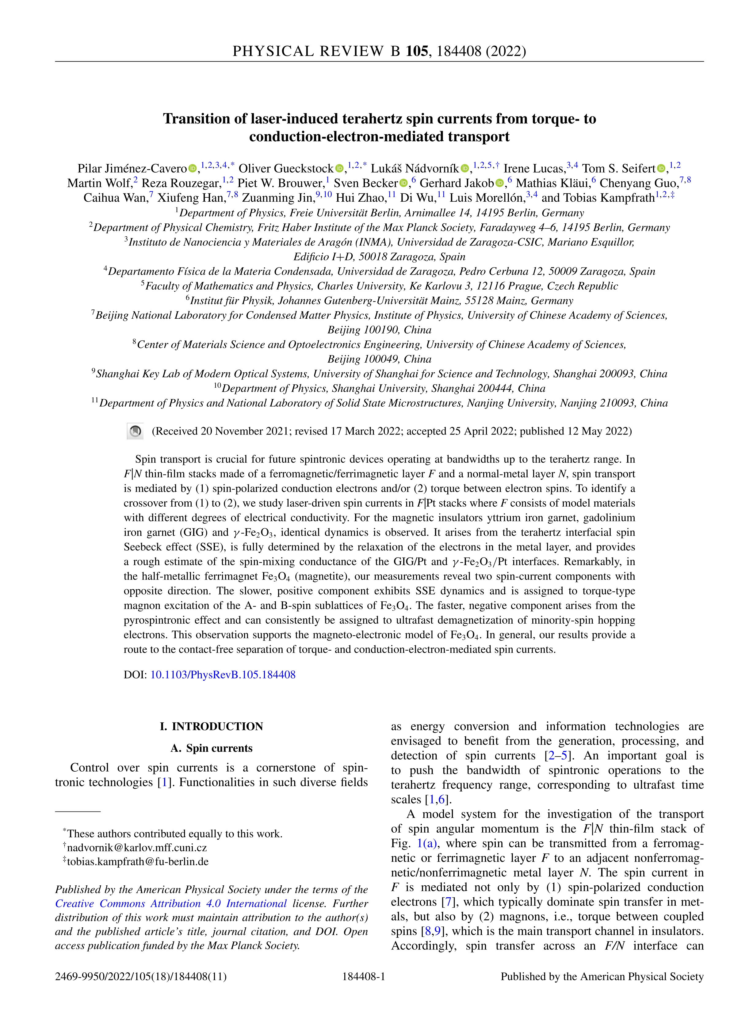 Transition of laser-induced terahertz spin currents from torque- to conduction-electron-mediated transport