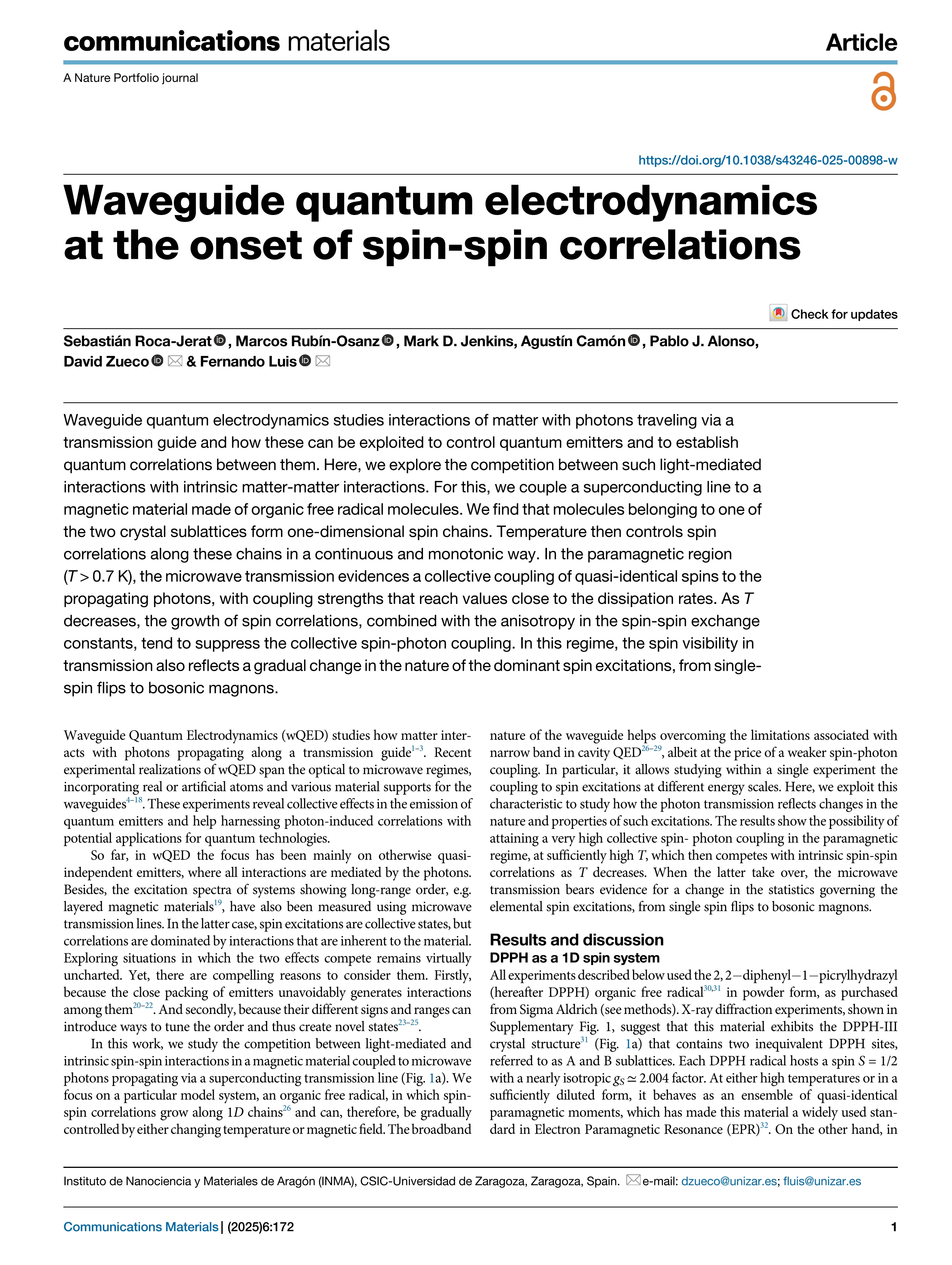 Waveguide quantum electrodynamics at the onset of spin-spin correlations