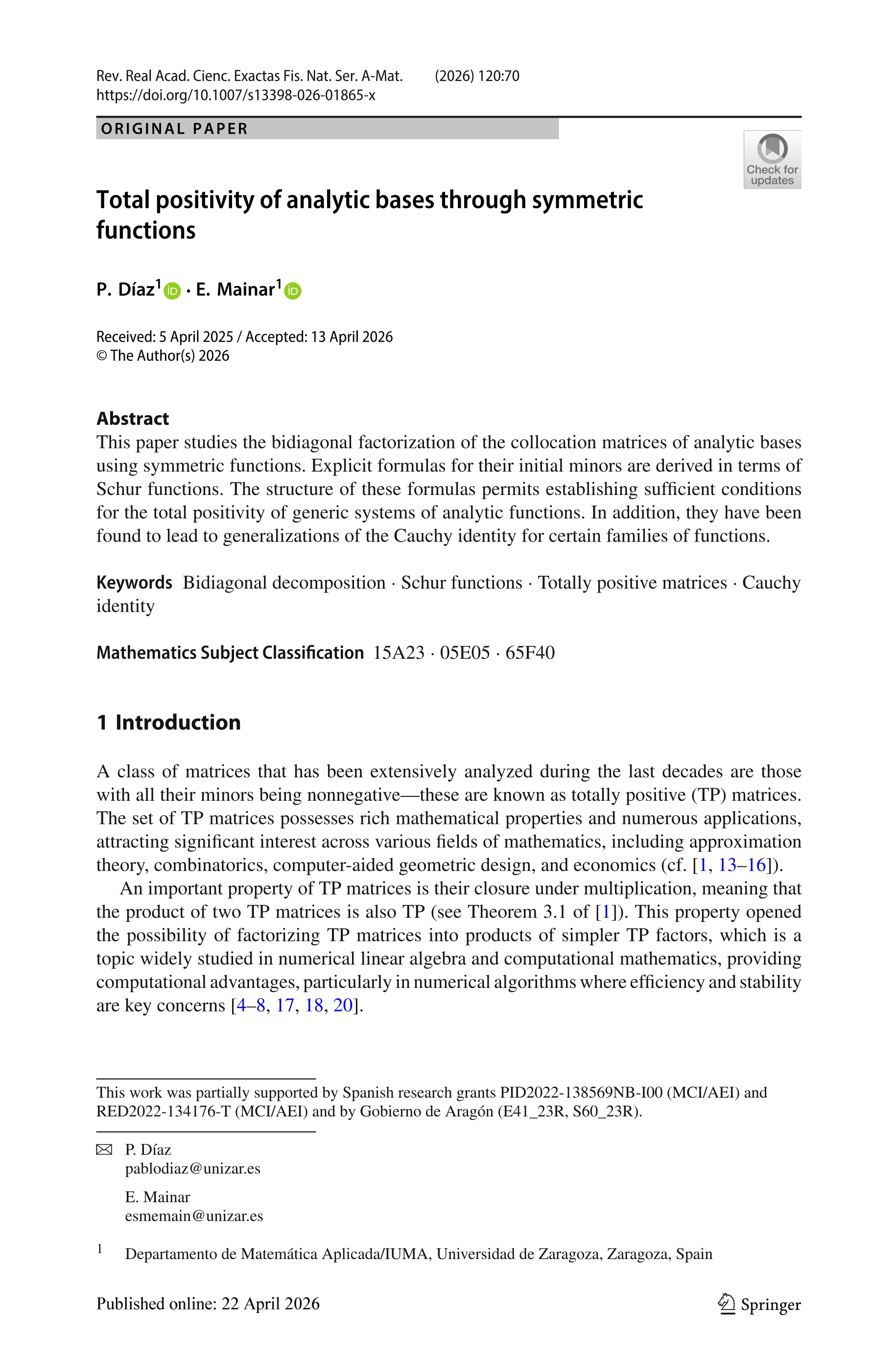 Total positivity of analytic bases through symmetric functions